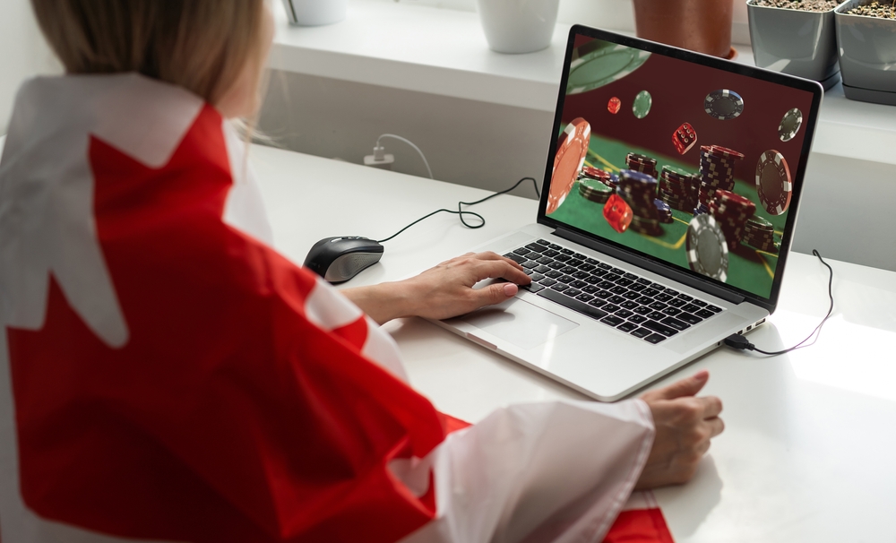 Woman playing online casino wrapped in Canadian flag