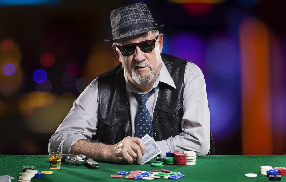 An older gentleman plays poker