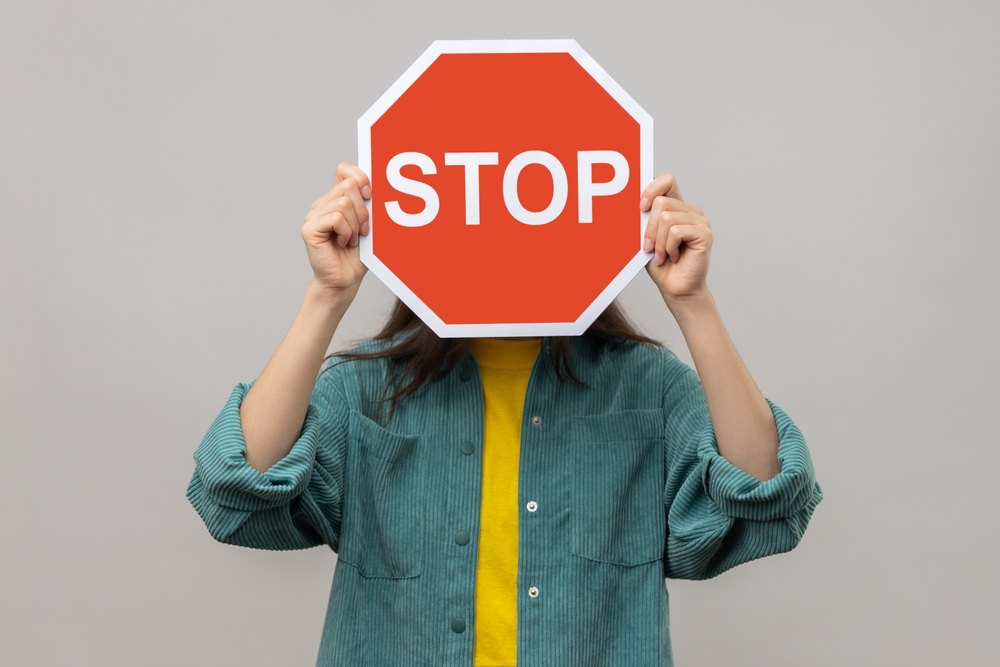 woman holding stop sign