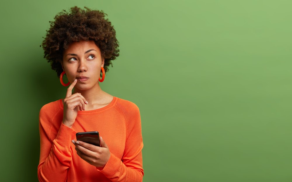 woman thinking with mobile phone