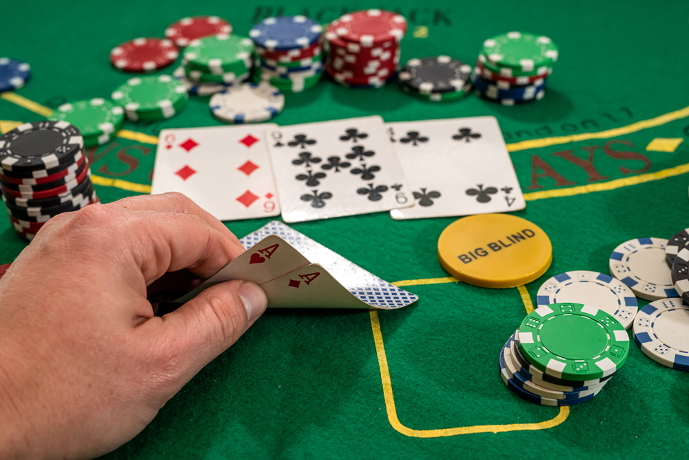 a poker player looks at their hand