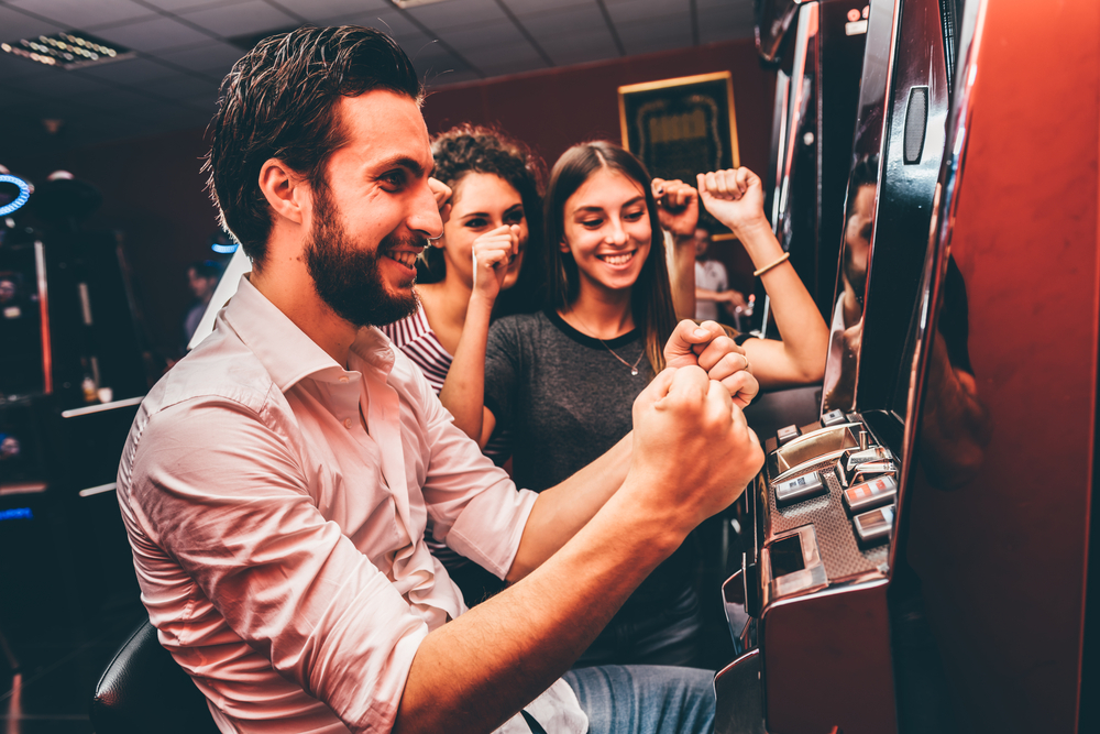 group playing slot machine