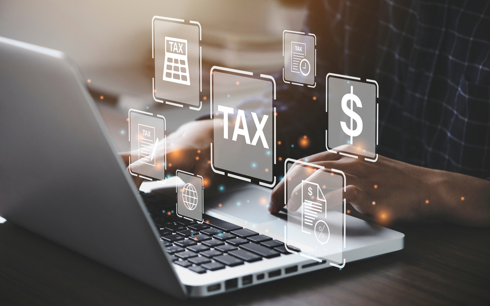 tax related images surround a laptop