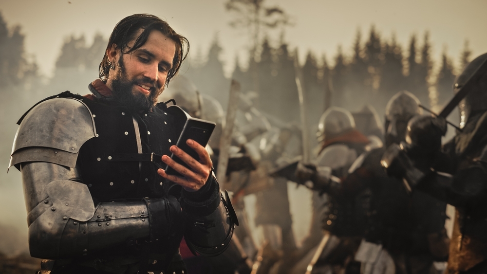 a warrior plays on his phone