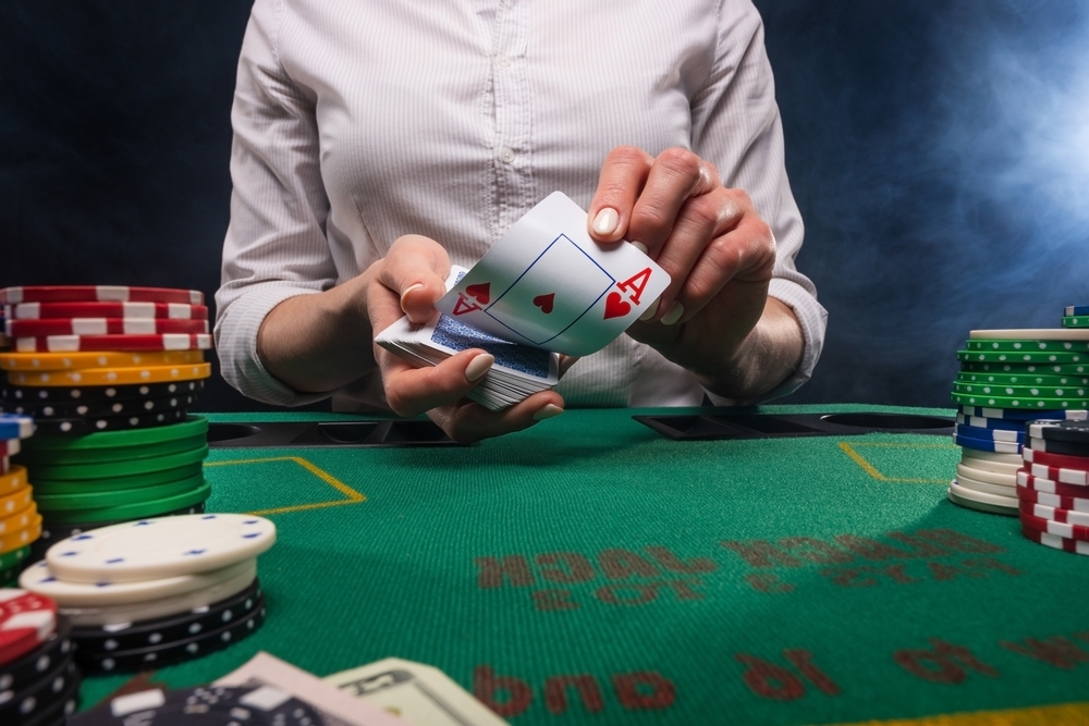 a croupier deals cards in a casino